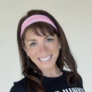 Michelle Burks - Yoga Teacher Asana at Home. close up photo. brown hair and pink headband. smilling
