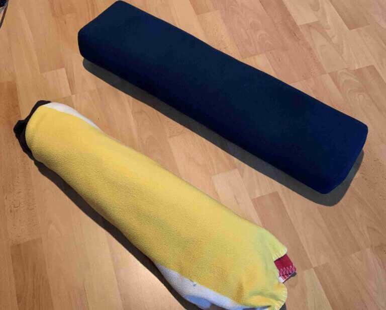 DIY YOGA Blocks and Props Blanket rolled up to make DIY yoga bolster substitute on Left. Used as a substitute yoga bolster to the Commercial grade yoga bolster on the right.