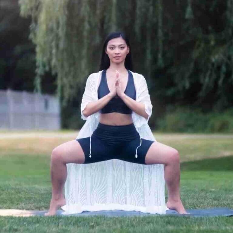 Female yoga teacher Blef demonstrating Goddess Pose yoga asana awareness sacral chakra awakening symptoms
