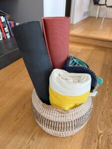 basket with two yoga mats and two blankets. a diy yoga mat solution