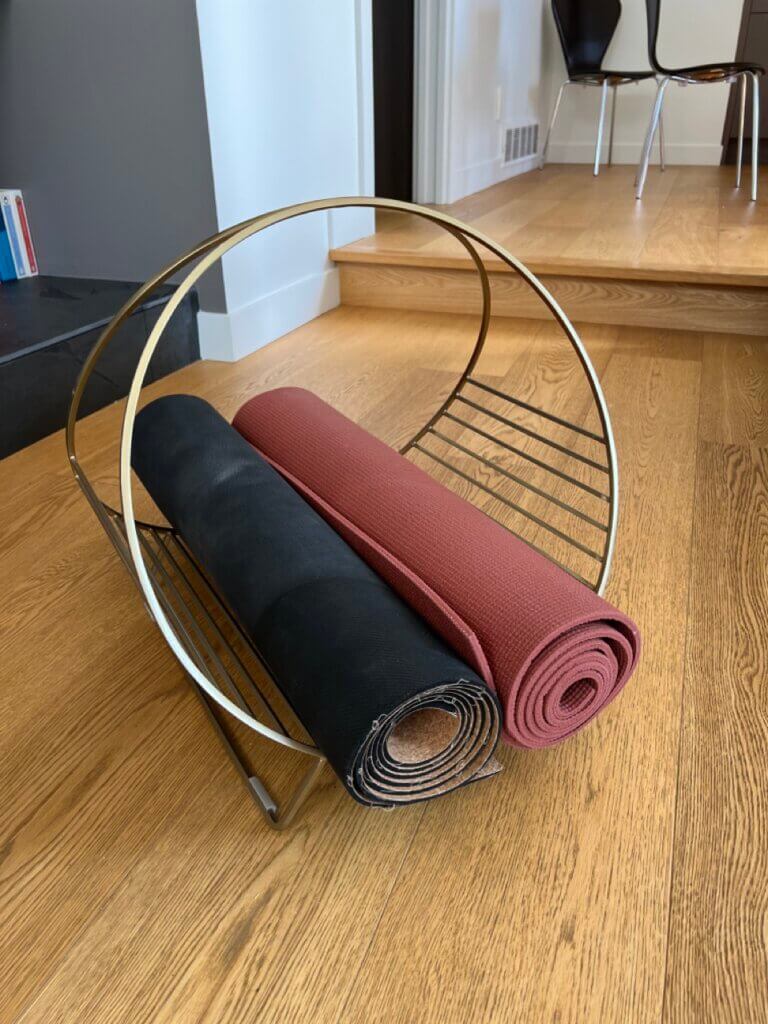 two yoga mats placed ina firewood holder diy yoga mat storage