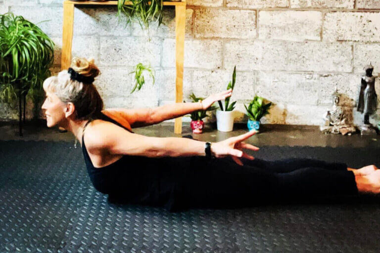 woman doing Locust Pose (Salabhasana) yoga for shoulder pain