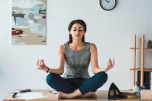 woman meditating over a yoga quote