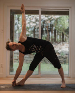 man doing yoga pose Extended Triangle Pose (Utthita Trikonasana) for shoulder pain. yoga blog