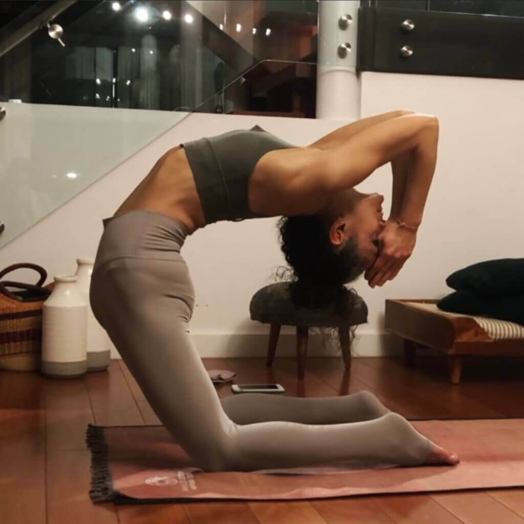 woman starting to do kapotasana ashtanga yoga asana. contortion poses