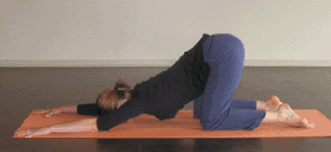 woman doing yin yoga on a mat. She's doing Anahatasana Pose the melting heart pose. a yoga pose in yin yoga