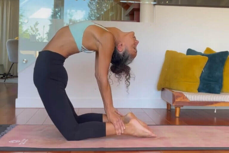 woman practicing camel pose to unblock chakra