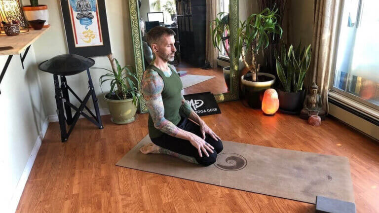 man doing saddle pose in yon yoga