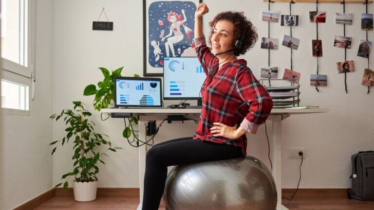 woman sitting on a yoga ball using the ball as an office chair. using the yoga ball size chart to help select a ball for its intended use and health