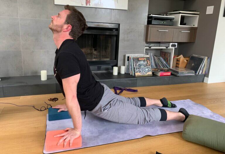 man doing Seal Yoga Pose with blocks under hands