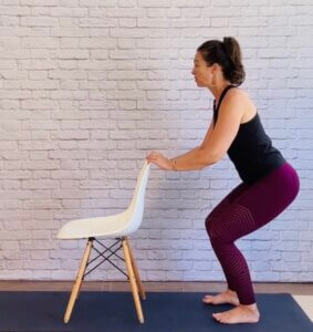 woman doing seated pose at her desk standing for printable sequence