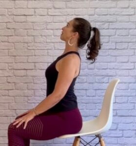 Woman doing Cow pose while seated for yoga at your desk printable