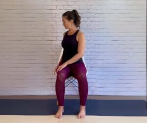 woman doing twist yoga pose while seated for prinatble sequence