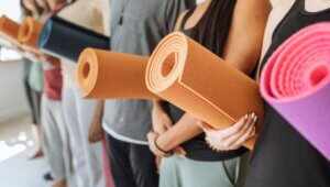 people holding yoga mats. PVC and TPE materials