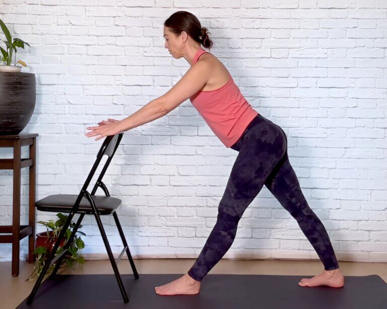 Christina Raskin Demonstrating advanced chair yoga downward facing dog pose