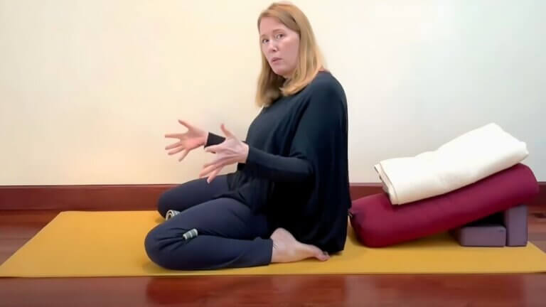 Yin Yoga pose with props demonstrating a functional approach