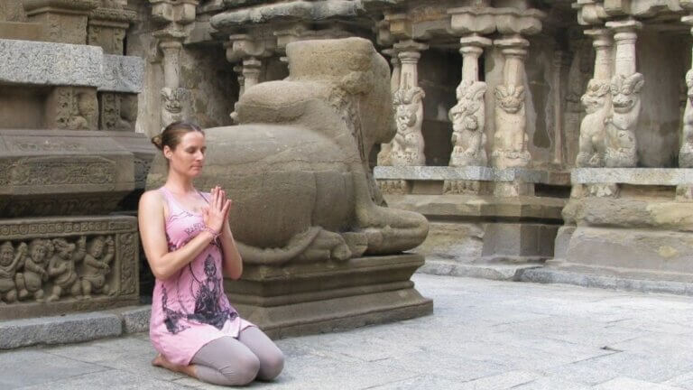 woman meditating on yoga philosophy at a temple