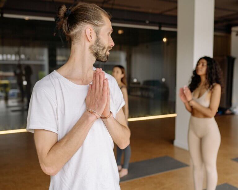 Yoga teacher listening to a student after practice