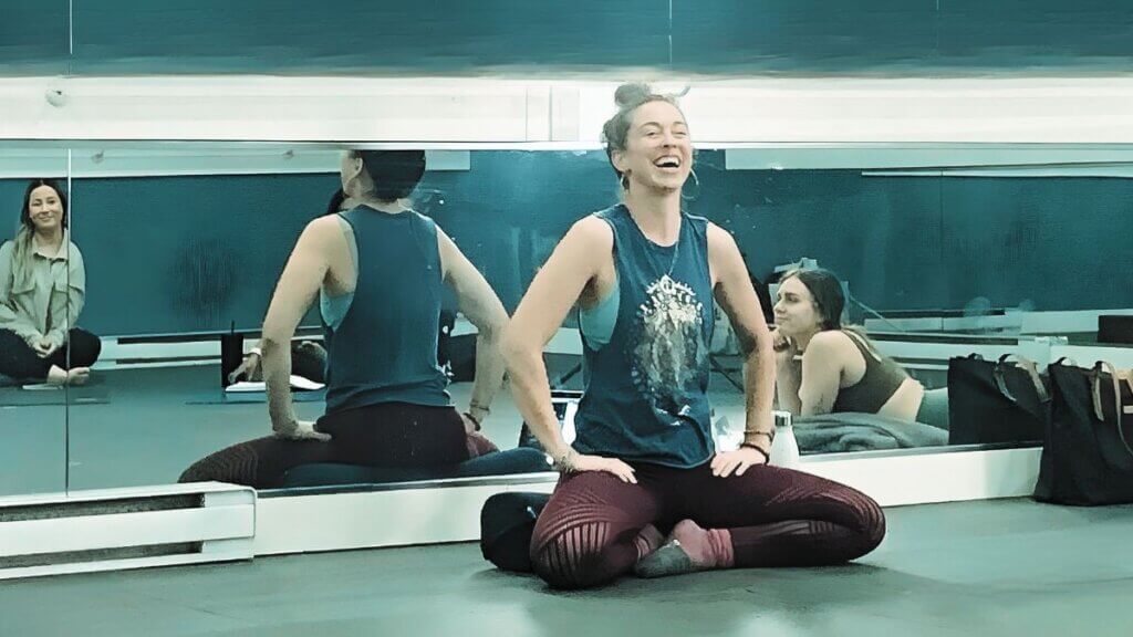 Christina Raskin, Yoga teacher engaging students during class with uplifting presence