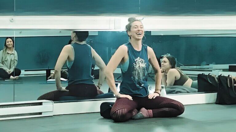 Christina Raskin, Yoga teacher engaging students during class with uplifting presence