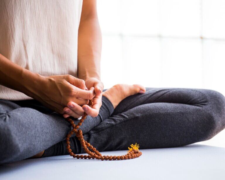 Yoga teacher meditating and reflecting before class