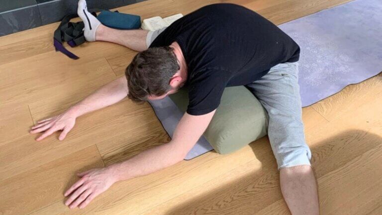Kevin Parenteau demonstrating Dragonfly pose with bolster