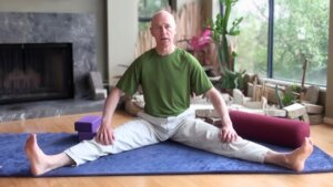 bernie Clark seated in Dragonfly Straddle pose yin yoga