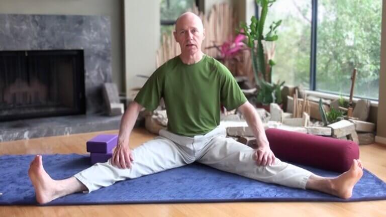 bernie Clark seated in Dragonfly Straddle pose yin yoga