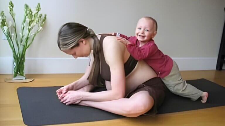 Fiona Stang practicing yoga at home with her child nearby