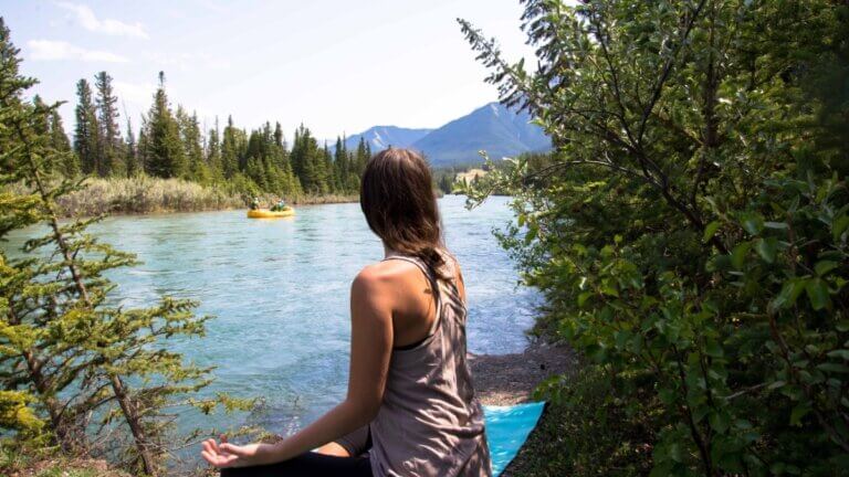 Amanda Kingsmith seated outdoors reflecting on intention for a yoga teaching business